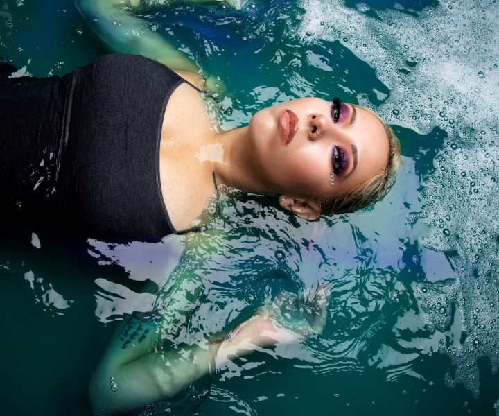 Glamour photo of woman lying in pool